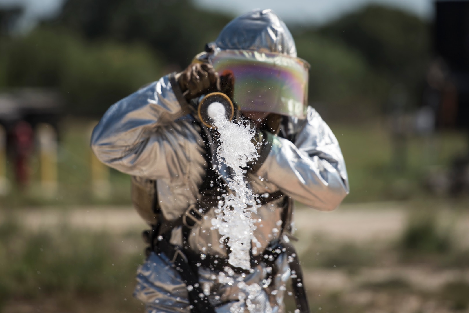 1st Lt. Clayton Schmitt, 902nd Security Forces Squadron operations officer, shoots a stream of water from a fire hose during the JBSA Battle of the Badges Sept. 12, 2015, at JBSA-Randolph. This year’s Battle of the Badges was comprised of three main events: a tactical shooting challenge, firefighter combat challenge and fire truck pull. The firefighter combat challenge tested members of both parties with an obstacle course that included carrying gear up three flights of stairs, hoisting a bundle of hose from the ground with a rope, dragging a weighted dummy and hitting a target with a charged fire hose.