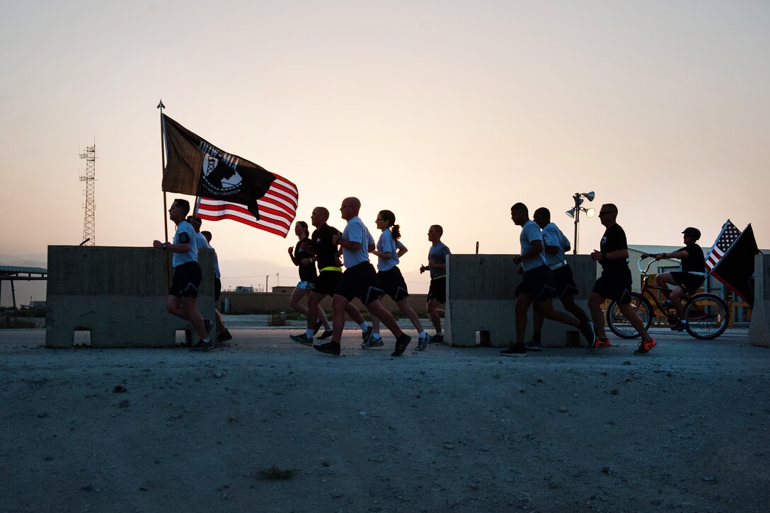 U.S. service members participate in a run to honor prisoners of war and those missing in action on Bagram Airfield, Afghanistan, Sept. 3, 2015. For 24 straight hours, service members kept the POW/MIA flag in constant motion to focus on American prisoners of war and those missing. U.S. Air Force photo by Tech. Sgt. Joseph Swafford
