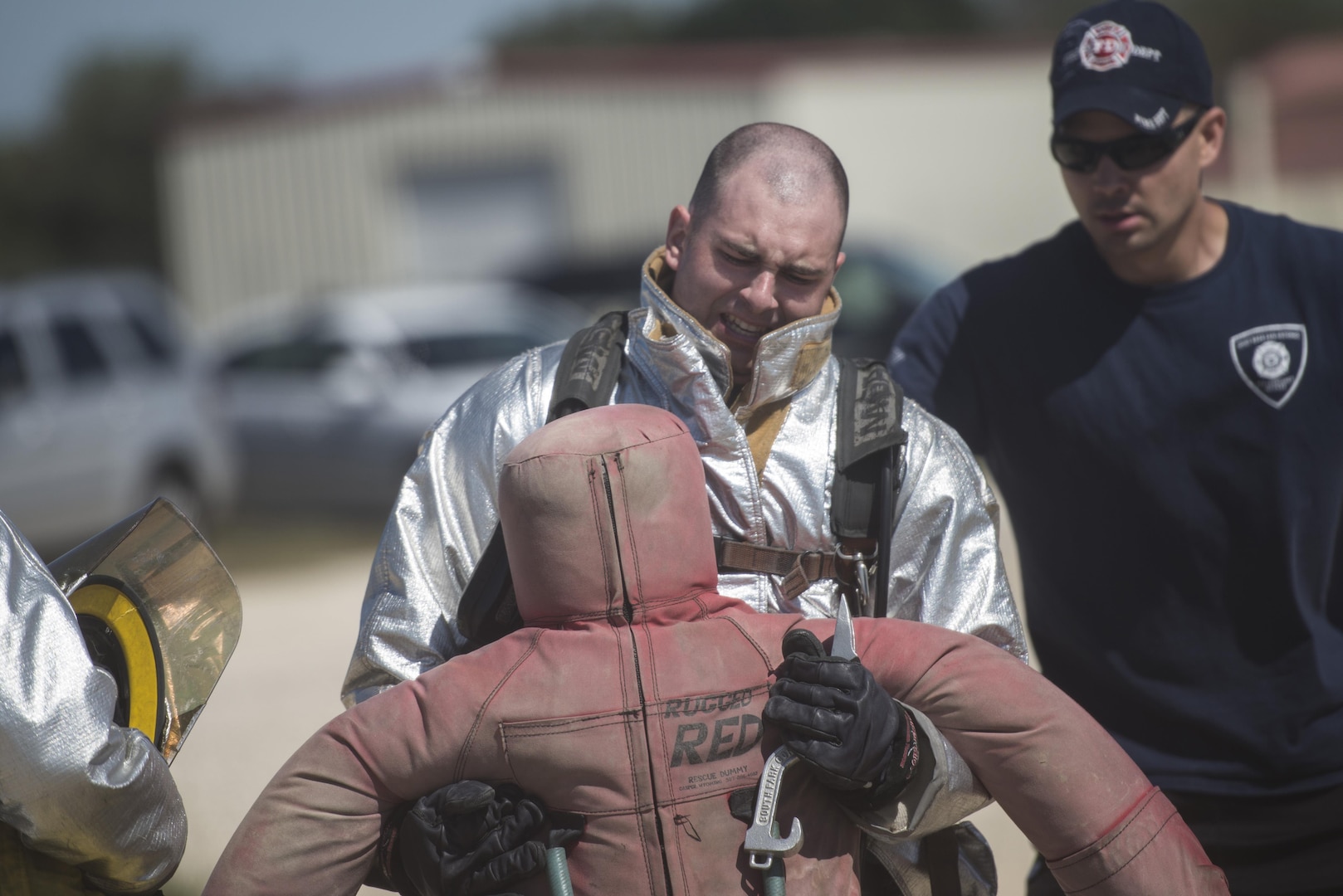 Airman 1st Class John Connor, 902nd Security Forces Squadron armorer, drags a 185-pound dummy during the firefighter combat challenge event of the JBSA Battle of the Badges Sept. 12, 2015, at JBSA-Randolph. This year’s Battle of the Badges was comprised of three main events for time: a tactical shooting challenge, firefighter combat challenge and fire truck pull. The firefighter combat challenge tested members of both parties with an obstacle course that included carrying gear up three flights of stairs, hoisting a bundle of hose from the ground with a rope, dragging a weighted dummy and hitting a target with a charged fire hose.
