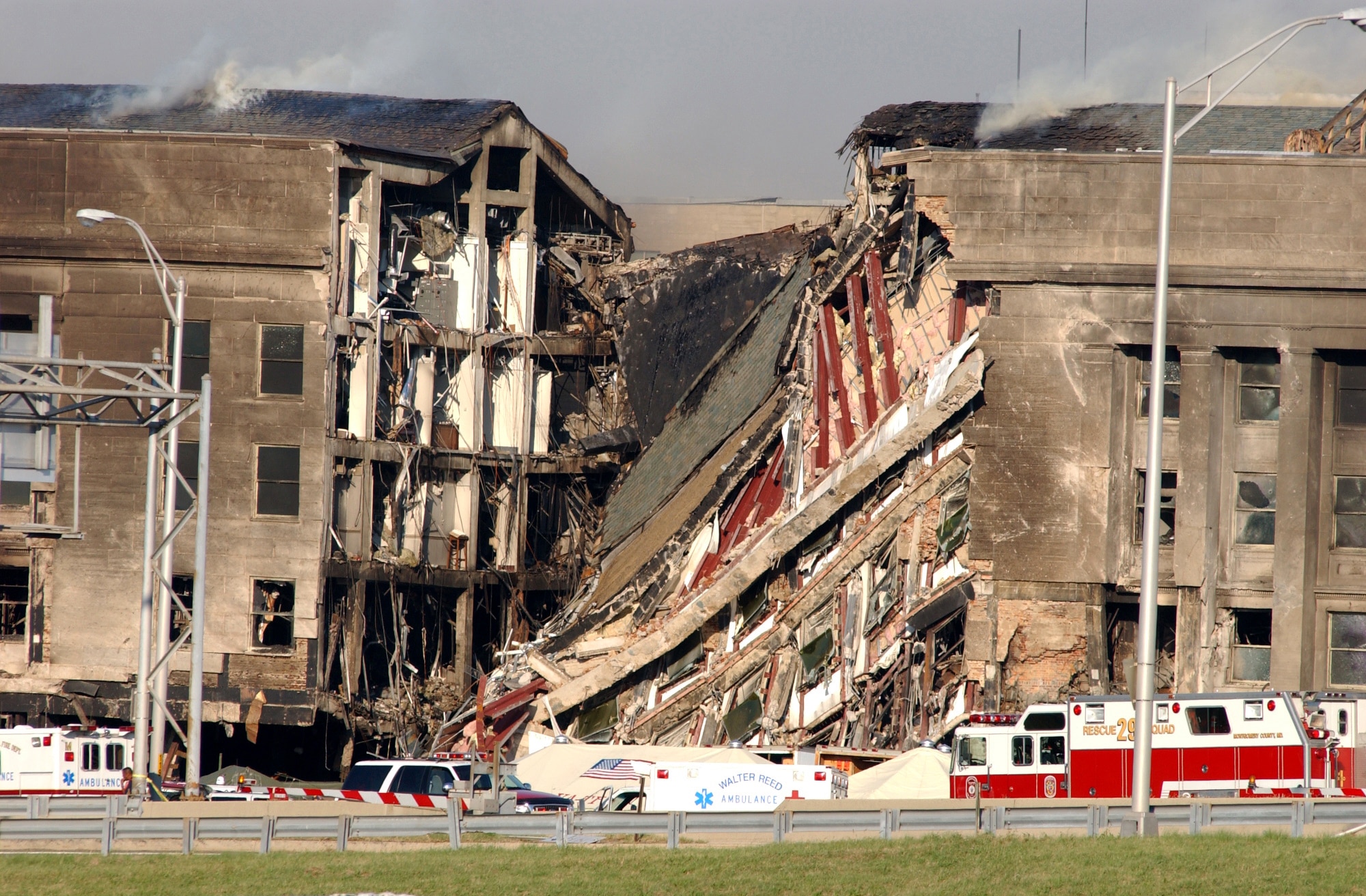 A 200-foot gash exposes interior sections of the Pentagon following a suspected terrorist crash of a commercial airliner into the southwest corner of the building. Part of the building has collapsed meanwhile firefighters continue to battle the flames and look for survivors. An exact number of casualties are unknown. The building was evacuated, as were the federal buildings in the Capitol area, including the White House. (U.S. Navy Photo/Photographers Mate 2nd Class Bob Houlihan) 