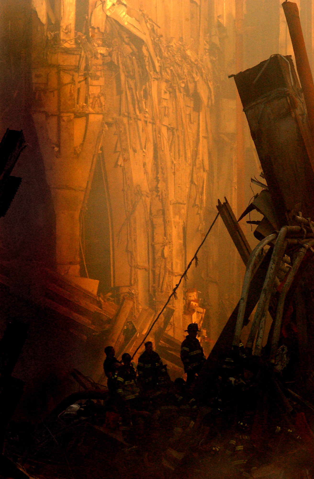 Rescue workers conduct search and rescue attempts, descending deep into the rubble of the World Trade Center. (U.S. Navy Photo/Photographer's Mate 2nd Class Jim Watson)