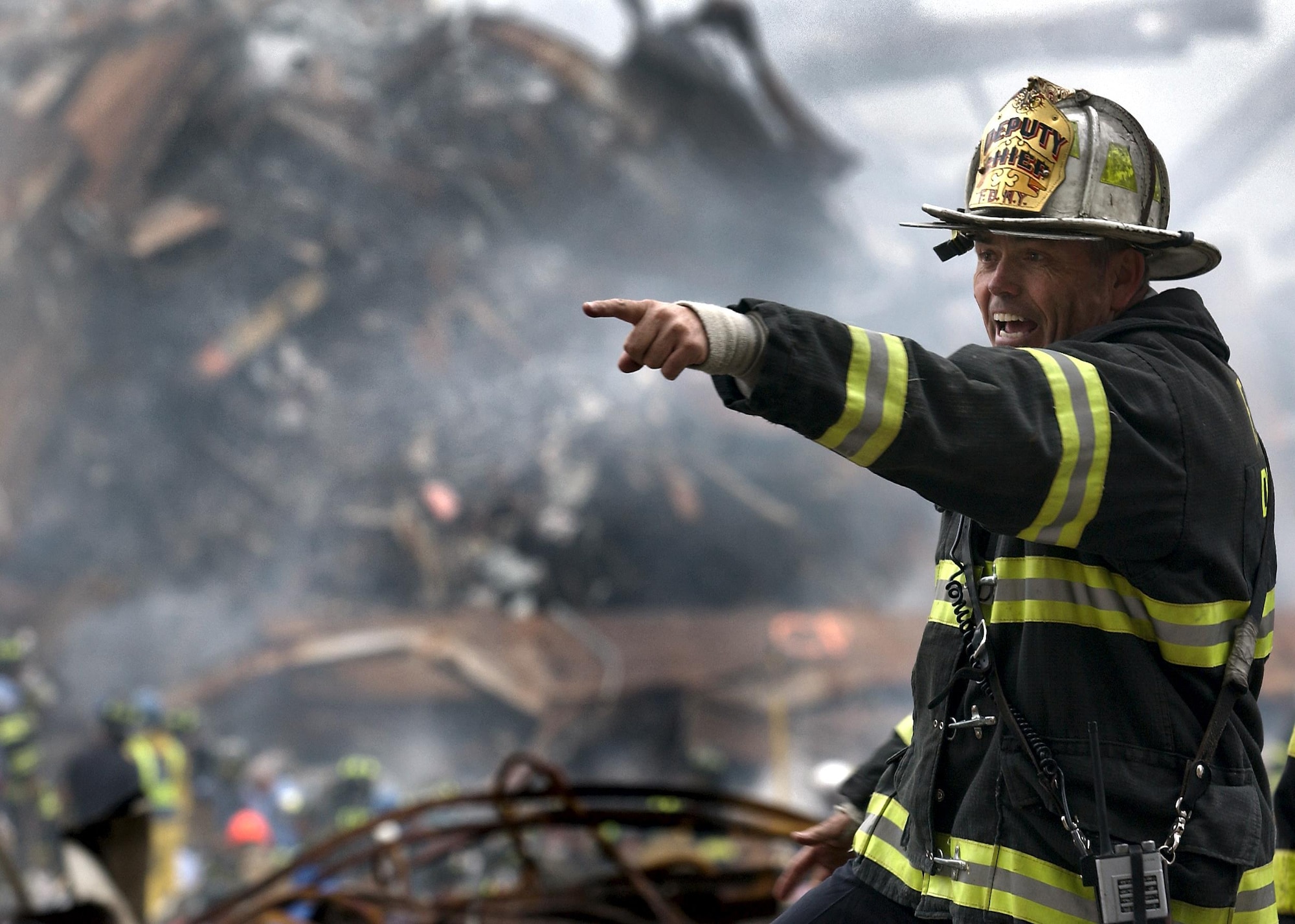 Retired Fire Chief Joseph Curry barks orders to rescue teams as they clear through debris that was once the World Trade Center. (U.S. Navy Photo/Journalist 1st Class Preston Keres)