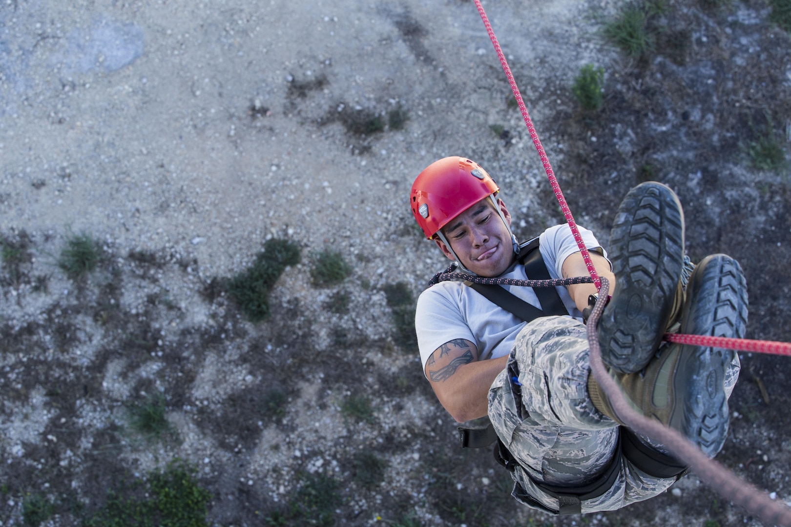 Senior Airman Christian Torres, 502nd Civil Engineer Squadron firefighter, performs an inversion technique during the repelling demonstration portion of the 2015 Battle of the Badges Sept. 12 at the Joint Base San Antonio-Randolph Camp Talon Fire Training Area. This year’s Battle of the Badges was comprised of three main events for time: a tactical shooting challenge, firefighter combat challenge and fire truck pull. In addition the traditional challenges, this year’s event gave both defenders and firefighters the opportunity to show case parts of their missions with repelling, military working dog and Taser demonstrations.