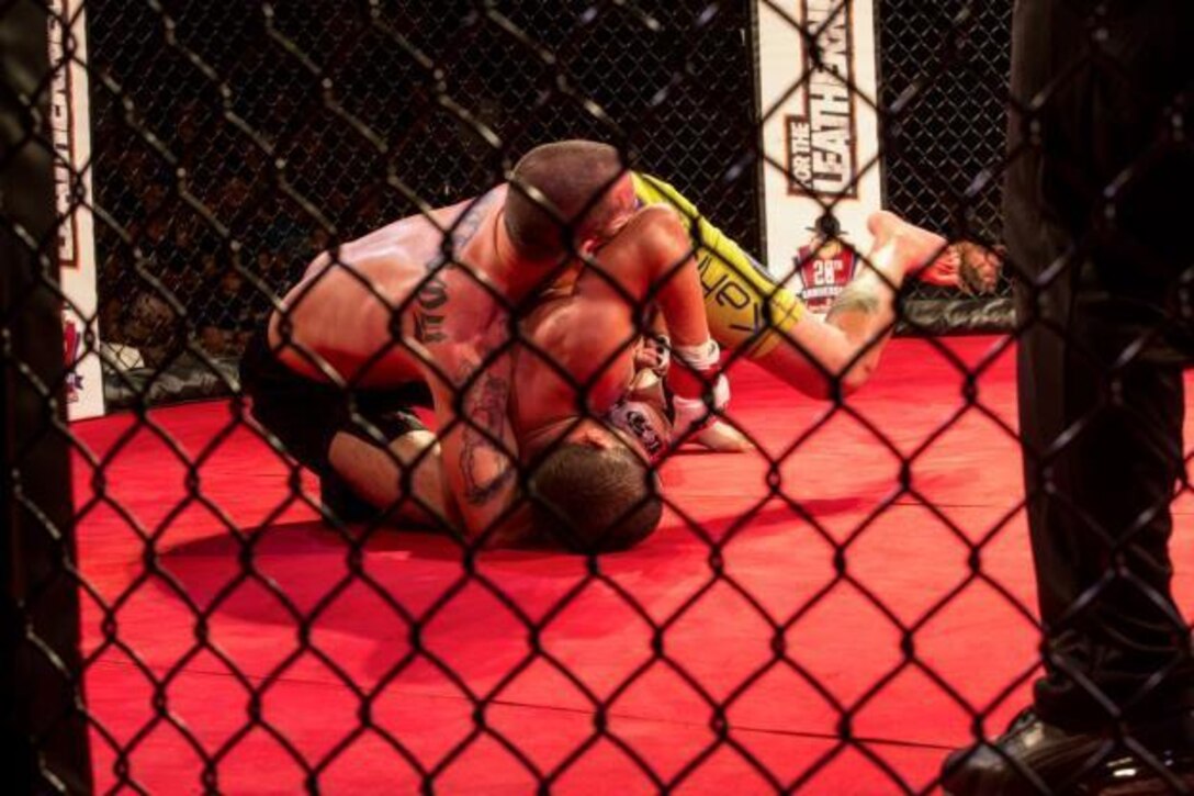 Ran Weathers and Jay Haas grapple on the ground to maintain dominance and control of each other during Leatherneck IV, MMA Fight Night Live aboard Camp Lejeune, N.C., Sept. 2, 2015. Marines gathered at Goettge Memorial Field House to watch nine professional fights and meet special guest five-time UFC Champion and UFC Hall of Famer, Randy Couture. (U.S. Marine Corps photo by Lance Cpl. Aaron Kane Fiala/Released)