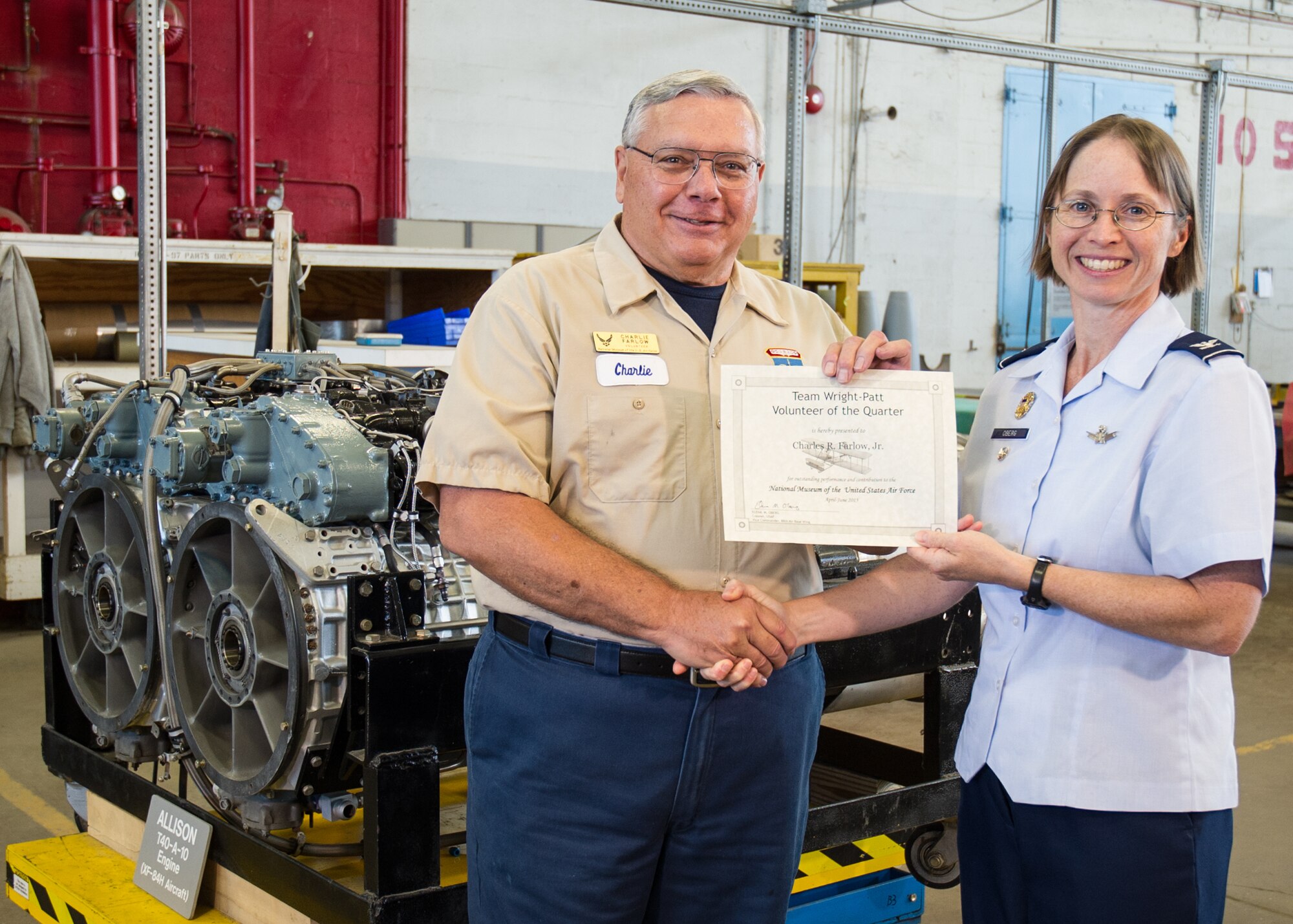 DAYTON, Ohio -- 88th Air Base Wing Vice Commander Col. Elena M. Oberg presents Huber Heights resident Charles Farlow Jr. with the Team Wright-Patt "Volunteer of the Quarter" award for the second quarter of 2015 on Sept. 14, 2015. (U.S. Air Force photo)  