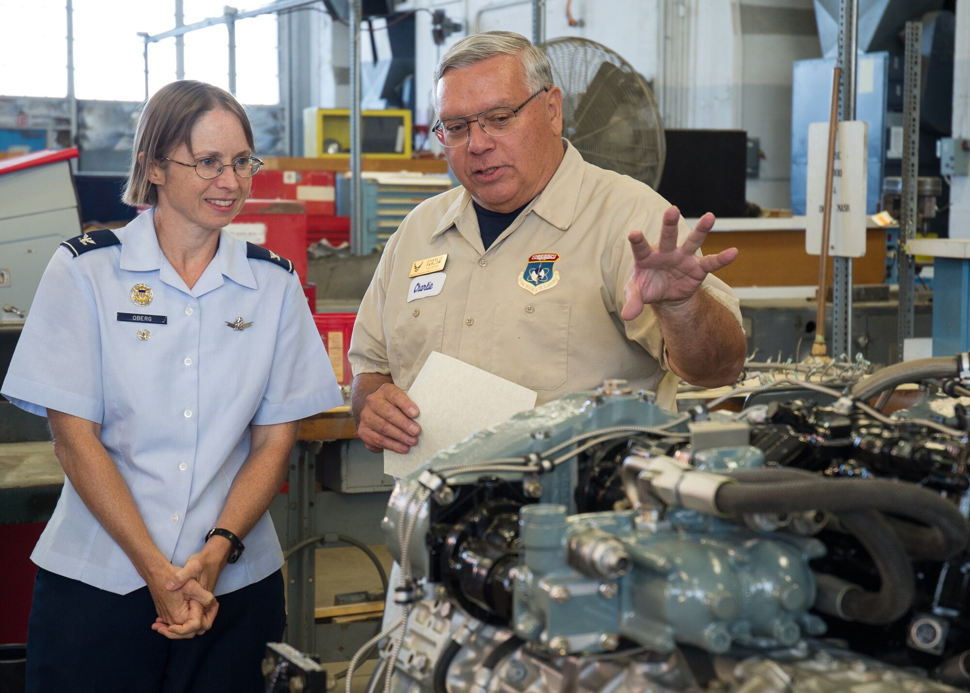 DAYTON, Ohio -- 88th Air Base Wing Vice Commander Col. Elena M. Oberg (left) views a restored engine with Huber Heights resident Charles Farlow Jr. (right). Farlow was awarded the Team Wright-Patt "Volunteer of the Quarter" award for the second quarter of 2015 on Sept. 14, 2015. (U.S. Air Force photo)