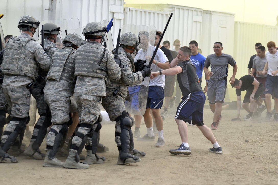 Airmen respond to a simulated riot as part of Operation Golden Gate at the Fresno Air National Guard Base in California, Sept. 13, 2015. The airmen are assigned to the 144th Security Forces Squadron. California National Guard photo by Air Force Senior Airman Klynne Pearl Serrano