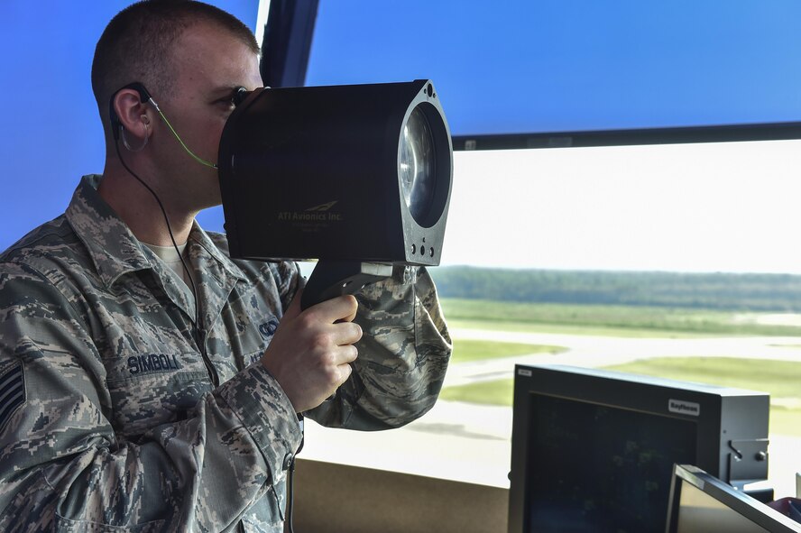 Senior Airman Carmen Simboli, 1st Special Operations Support Squadron air traffic controller, demonstrates how to operate the light gun at Hurlburt Field, Fla., August 26, 2015. The light gun is used to direct air traffic in the air and on the ground when radio communications are unavailable. (U.S. Air Force photo/Senior Airman Jeff Parkinson)