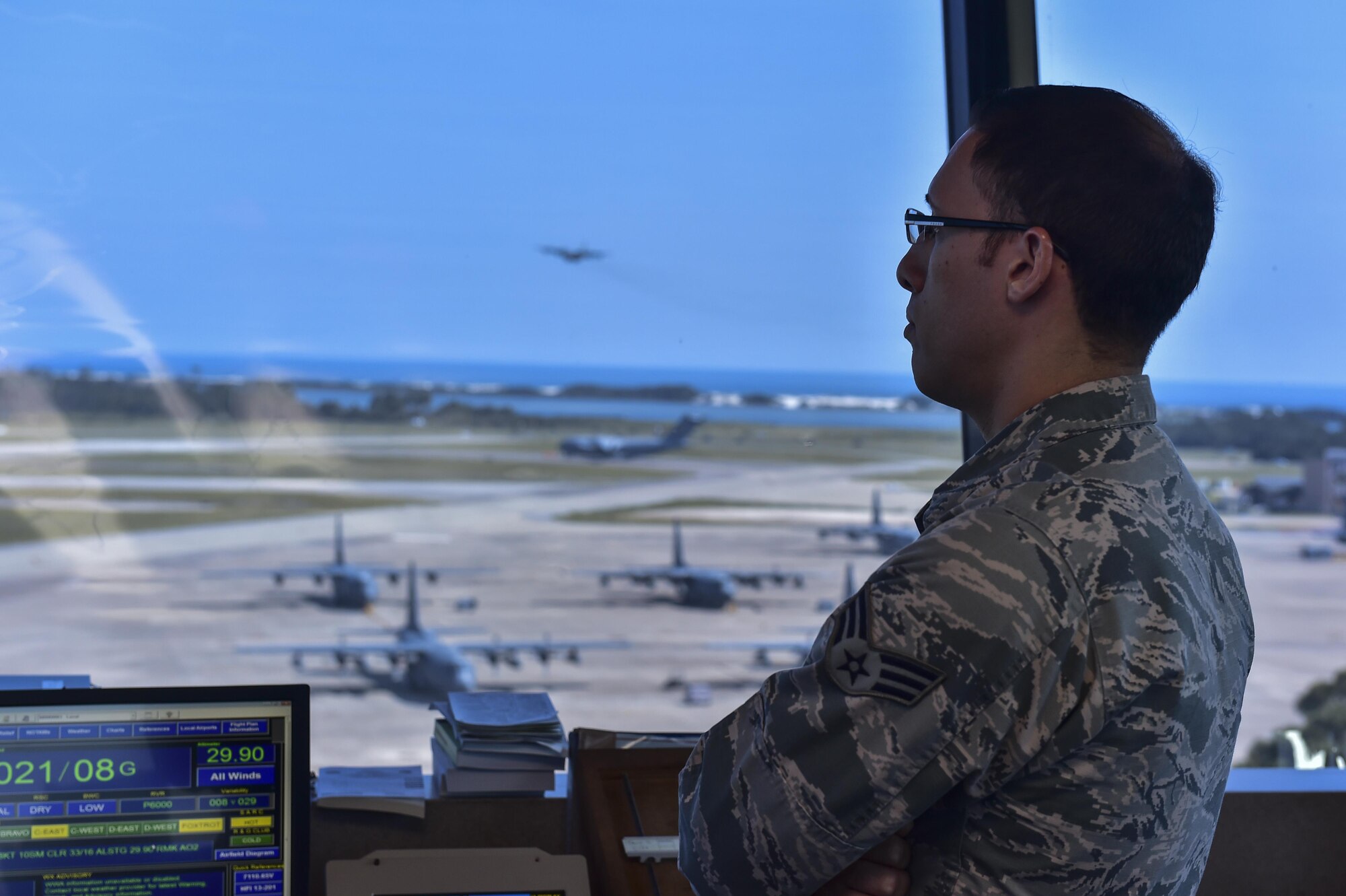 Senior Airman Karlos Malave, 1st Special Operations Support Squadron air traffic controller, monitors aircraft movement at Hurlburt Field, Fla., August 25, 2015. Air traffic controllers provide a safe, orderly and expeditious flow of aircraft on the flightline and in the air. (U.S. Air Force photo/Senior Airman Jeff Parkinson)