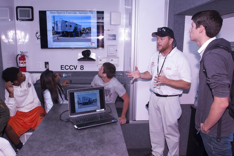 Kevin Gatlin, Nashville District Emergency Management Branch natural disaster manager, talks with students at Stratford STEM Magnet School in Nashville, Tenn., Sept. 11, 2015 about various missions of a U.S. Army Corps of Engineers Emergency Command and Control Vehicle during a Patriot Day tour of the vehicle.