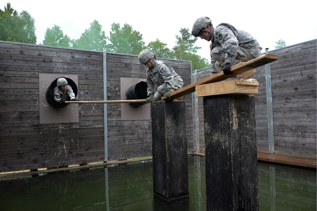U.S. soldiers lay boards during the 2015 European Best Warrior Competition at the Grafenwoehr Training Area in Germany, Sept. 14, 2015. Some 22 candidates are participating in the annual weeklong competition, the most prestigious competitive event of its kind in the region. The soldiers are assigned to U.S. Army Europe. U.S. Army photo by Gertrud Zach