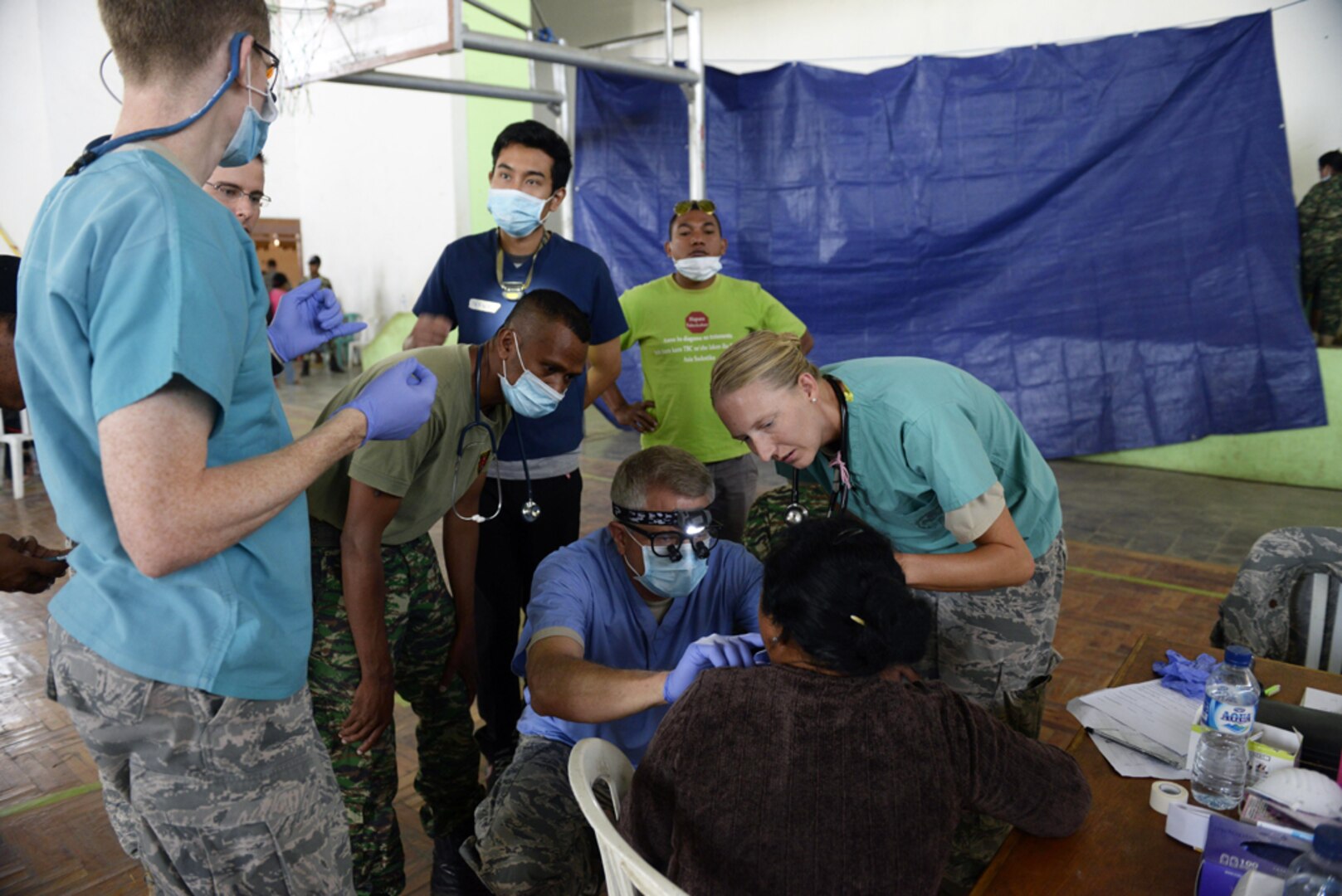 Pacific Angel 15-2 general practice physicians and dentists take a look at a patient's oral sore during a health services outreach Sept. 11, 2015, in Baucau, Timor-Leste. Pacific Angel is a multilateral humanitarian assistance civil military operation, which improves military-to-military partnerships in the Pacific while also providing medical health outreach, civic engineering projects and subject matter exchanges among partner forces. (U.S. Air Force photo by Staff Sgt. Alexander W. Riedel/Released)