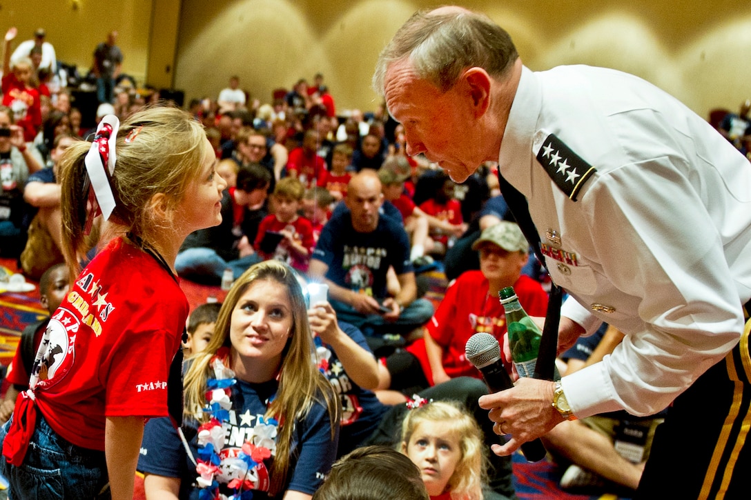 Army Gen. Martin E. Dempsey, chairman of the Joint Chiefs of Staff,  talks with a child at the annual National Military Survivor Seminar and Good Grief Camp in Crystal City,Va, May 25, 2012. The child is participating on behalf of the Tragedy Assistance Program for Survivors, or Taps, which sponsored the event. DoD photo by D. Myles Cullen