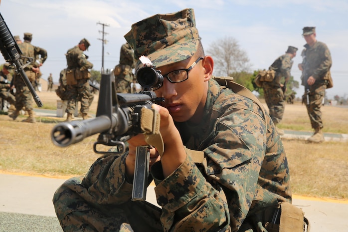 Recruit Elvis P. Nguyen, Echo Company, 2nd Recruit Training Battalion, practices the sitting firing position during Grass Week at Edson Range, Weapons and Field Training Battalion, Marine Corps Base Camp Pendleton, Calif., Sept. 9. Today, all males recruited from west of the Mississippi are trained at MCRD San Diego. The depot is responsible for training more than 16,000 recruits annually. Echo Company is scheduled to graduate Oct. 30.