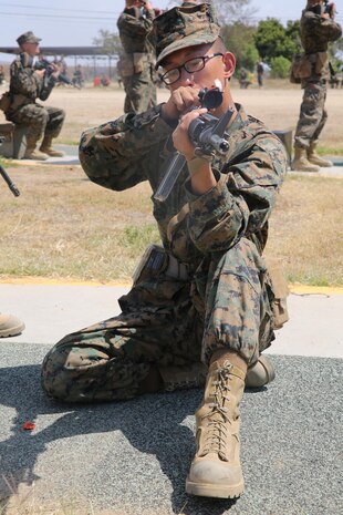 Recruit Elvis P. Nguyen, Echo Company, 2nd Recruit Training Battalion, practices the kneeling position during Grass Week at Edson Range, Weapons and Field Training Battalion, Marine Corps Base Camp Pendleton, Calif., Sept. 9. The recruits spent one week learning about the different fundamentals of firing. Today, all males recruited from west of the Mississippi are trained at MCRD San Diego. The depot is responsible for training more than 16,000 recruits annually. Echo Company is scheduled to graduate Oct. 30.               
