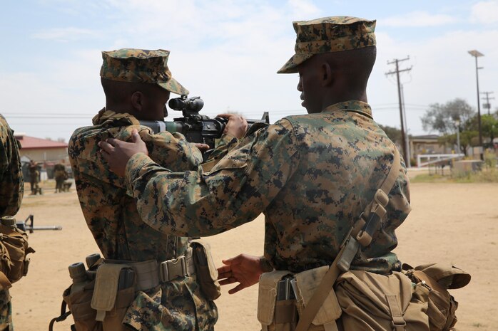 Recruit Drace R. Taylor (left) and Recruit Aaron S. Darby, Echo Company, 2nd Recruit Training Battalion, help each other master the standing firing position during Grass Week at Edson Range, Weapons and Field Training Battalion, Marine Corps Base Camp Pendleton, Calif., Sept. 9. Recruits also learned the kneeling, sitting and prone firing position, and worked together in trying to become more comfortable in executing them. Today, all males recruited from west of the Mississippi are trained at MCRD San Diego. The depot is responsible for training more than 16,000 recruits annually. Echo Company is scheduled to graduate Oct. 30.