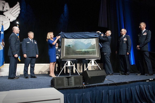 Air Force Secretary Deborah Lee James and Maj. Warren Neary, the Air Force Space Command historian and an Air Force Art Program artist, unveil the painting “That Others May Live” during the Air Force Association Air and Space Conference and Technology Exposition, Washington, D.C., Sept. 14, 2015. “That Others May Live” documents the rescue of Marcus Luttrell, a Navy SEAL, in June 2005 by Reservists from the 920th Rescue Wing at Patrick Air Force Base, Florida. The rescue was dramatized in the movie “The Lone Survivor.” (U.S. Air Force photo/Staff Sgt. Kat Justen)