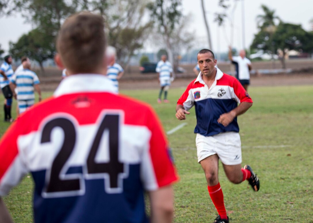 U.S. Marine Corps Staff Sgt. Alex Deykerhoff, a platoon sergeant with Company A, 1st Battalion, 4th Marine Regiment, Marine Rotational Force – Darwin, runs across the field during the 9/11 memorial rugby match at the Defence Establishment Berrimah rugby field, Northern Territory, Australia Sept. 11. The annual match was established with the first game played between the 15th Marine Expeditionary Unit and the Stray Cats social rugby club on Sept. 11, 2001, right before the terrorist attacks, and has become a commemorative match for each rotation of MRF-D. Participating in the match was an excellent opportunity to improve Marines’ knowledge of Australian culture and ultimately strengthened our bond as allies. 