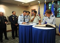 Gen. Lori J. Robinson, Pacific Air Forces commander, signs a guest book for the Pacific Air Chiefs Symposium, and Air Marshal Gavin Davies, Chief of the Royal Australian Air Force, signs a greetings letter to U.S. Pacific Command commander, Adm. Harry B. Harris, Jr., at Joint Base Pearl Harbor-Hickam, Hawaii, Sept. 12, 2015. Robinson, Davies and Air Chiefs from Bangladesh, Cambodia, Nepal, Japan, Mongolia and the Philippines spent two days in Hawaii discussing air operations in the Pacific region, and attending the 68th Annual Air Force Birthday Ball before heading to Washington, D.C., for the Air Force Association Annual Air and Space Conference and Technology Exhibition. The symposium helped further the Air Force's partnership with the countries by showcasing PACAF's use of airpower in humanitarian assistance and disaster relief operations and providing a forum for the Air Chiefs to discuss training standardization and improve interoperability. (U.S. Air Force photo by Staff Sgt. Alexander Martinez/Released)