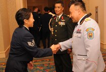 A Pacific Air Forces Airman greets Col. Shiileg Enkhbat, commander of Mongolian Air and Air Defense Forces, while Brig. Gen. Sudheer Shrestha, Nepalese Director General of Army Aviation, looks on at the 68th Annual Air Force Birthday Ball in Honolulu, Hawaii, Sept. 11, 2015. Enkhbat, Shrestha and Air Chiefs from Bangladesh, Cambodia, Japan and the Philippines attended the ball as special guests of PACAF Commander Gen. Lori J. Robinson before heading to Washington, D.C., for the Air Force Association Annual Air and Space Conference and Technology Exhibition. The Air Chiefs were in Hawaii as part of the Pacific Air Chiefs Symposium, which helped further the Air Force's partnership with the countries by showcasing PACAF's use of airpower in humanitarian assistance and disaster relief operations and providing a forum for the Air Chiefs to discuss training standardization and improve interoperability. (U.S. Air Force photo by Master Sgt. Matthew McGovern/Released)