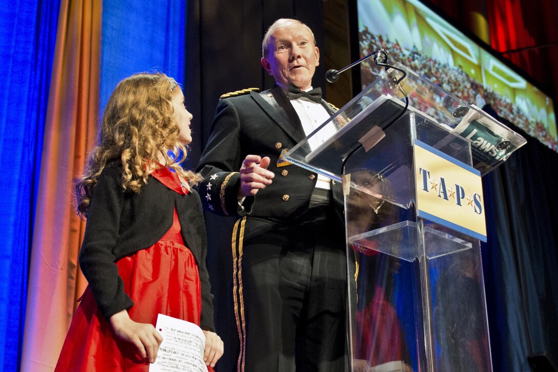 Army Gen. Martin E. Dempsey, chairman of the Joint Chiefs of Staff, speaks to the audience as Lizzy Yaggy, surviving daughter of Marine Corps Maj. David Laurence Yaggy, stands next to him during the 2014 Tragedy Assistance Program for Survivors Honor Guard Gala at the National Building Museum in Washington, D.C., March 27, 2014. DOD photo by U.S. Navy Petty Officer 1st Class Daniel Hinton