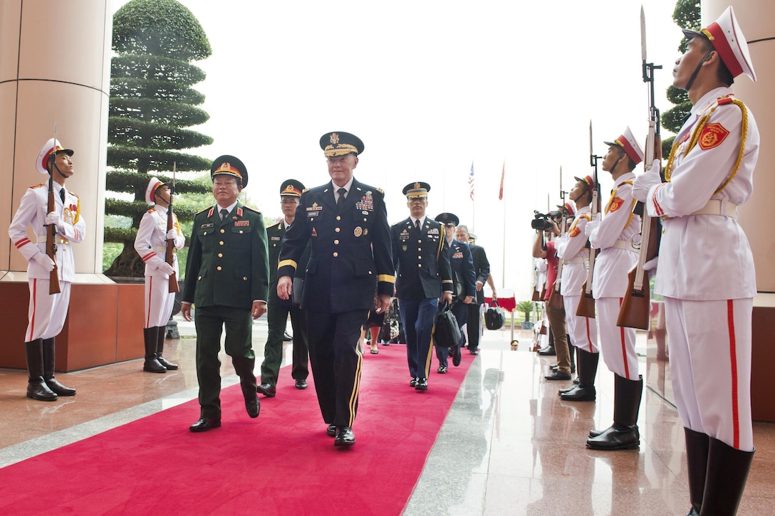 U.S. Army Gen. Martin E. Dempsey, chairman of the Joint Chiefs of Staff, walks with Vietnamese Chief of Defense Lt. Gen. Do Ba Ty at the Ministry of Defense in Hanoi, Vietnam, Aug. 14, 2014. Dempsey was the first chairman to visit the country since the Vietnam War. DoD photo by D. Myles Cullen