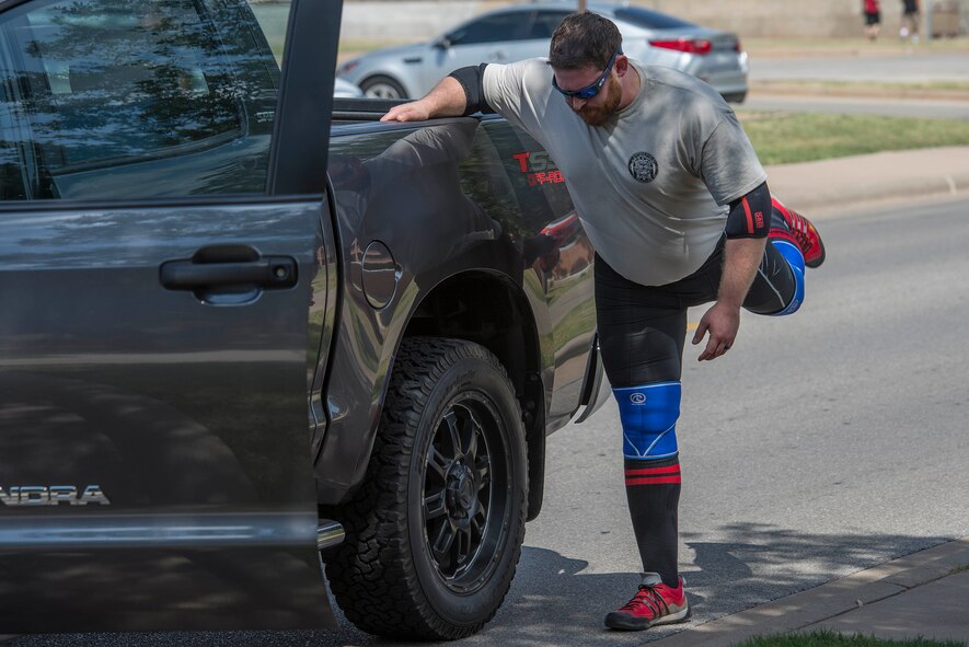 Mike Battaglino warms up before pulling a Wichita Falls fire truck at Sheppard Air Force Base, Texas, Sept. 12, 2015. Battaglino pulled the truck to raise money for retired U.S. Air Force Col. Shawn “Norm” Pederson who suffered an aneurism shortly after retiring. (U.S. Air Force photo by Senior Airman Kyle Gese/Released)