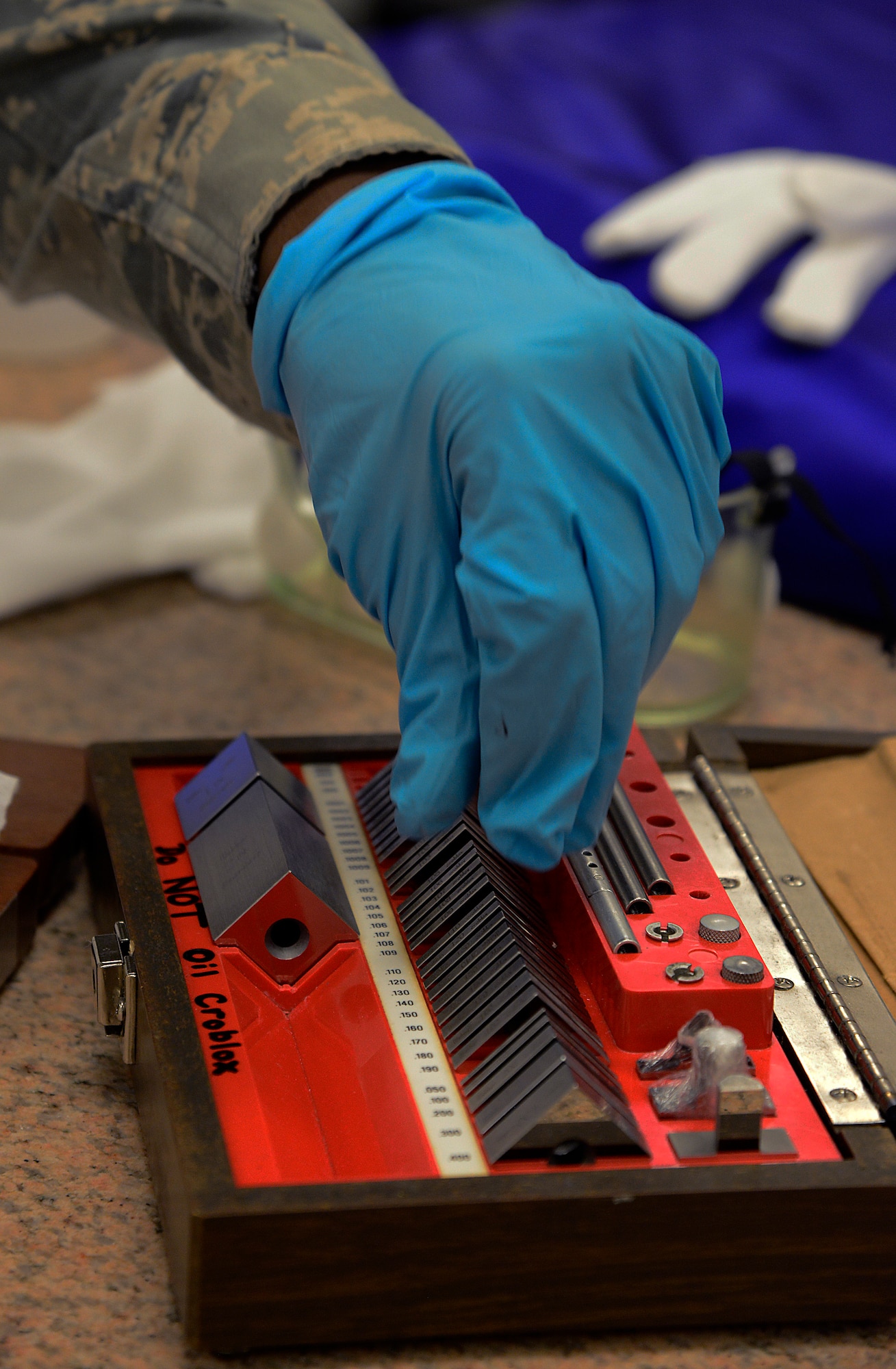 Airman 1st Class Marques Johnson, 51st Maintenance Squadron precision measurement equipment laboratory technician, puts away gauge blocks in the new PMEL facility on Osan Air Base, Republic of Korea. Gauge blocks are used to measure a series of comparisons and are at least four times more accurate than the unit being tested. (U.S. Air Force photo/Senior Airman Kristin High)