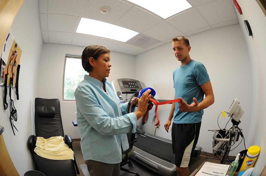 Lana R. Fred, Davis-Monthan Air Force Base Health and Wellness Center program coordinator, instructs U.S. Air Force Senior Airman Yevgeniy Sokolov, 355th Aircraft Maintenance Squadron crew chief, how to wear a VO2 max facemask at Davis-Monthan AFB, Ariz., Sept. 2, 2015. The mask covers both the mouth and nose while it measures the body’s oxygen intake though a tube connected to both the facemask and computer. (U.S. Air Force photo by Airman 1st Class Ashley N. Steffen/Released)