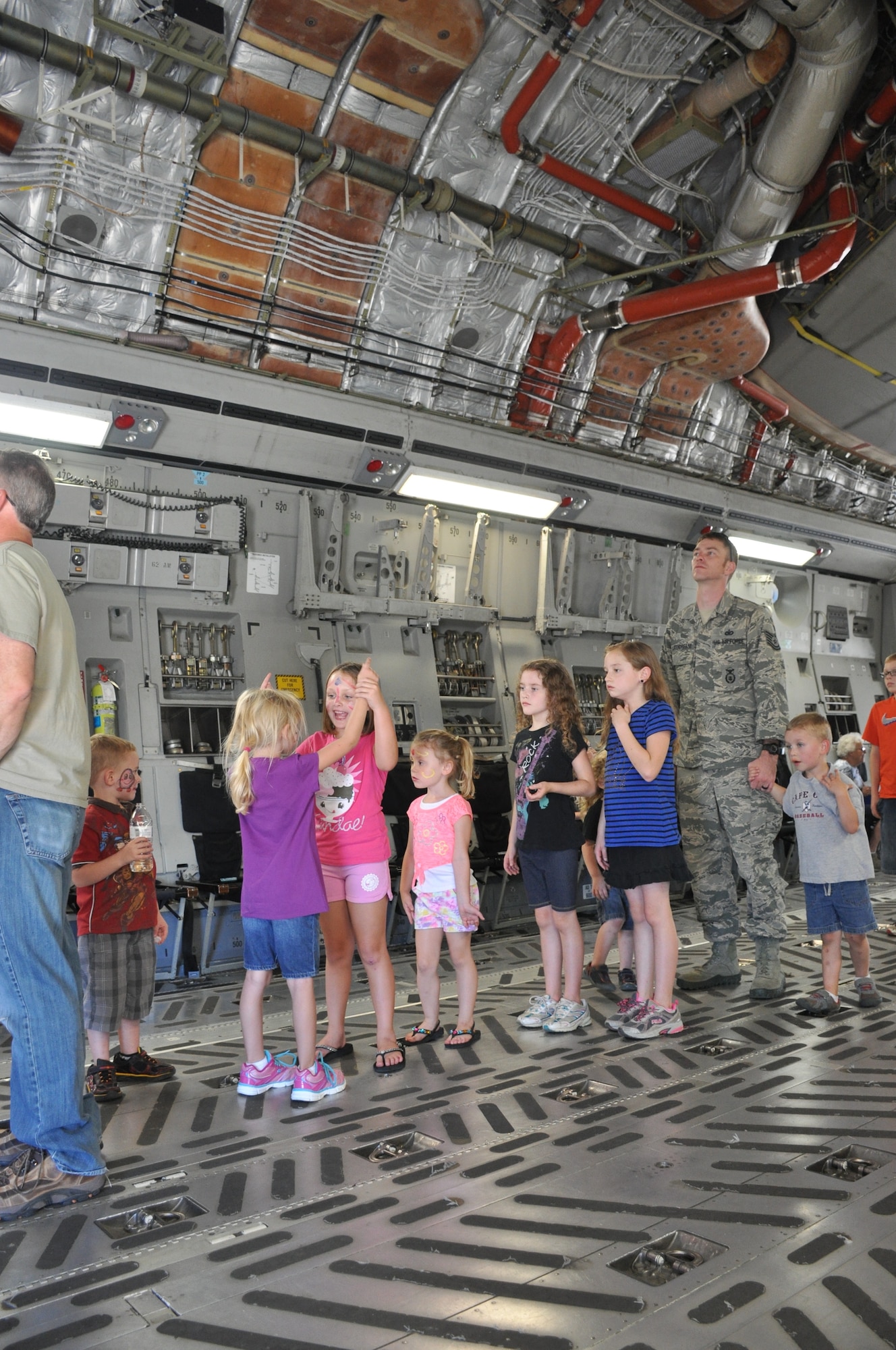 507th Air Refueling Wing members and their families wait in line to climb up into a C-17 Globemaster cockpit Sept. 12, 2015, at the 507th ARW Family Day celebration at Tinker Air Force Base, Okla. Each year, families are invited to the base for food, fun, and entertainment. (U.S. Air Force photo by Tech. Sgt. Lauren Gleason)