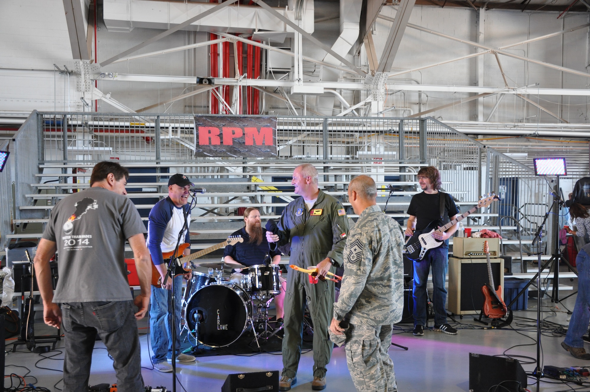 507th Air Refueling Wing commander Col. Brian S. Davis cracks a joke withTulsa rock cover band, RPM, before delivering a speech Sept. 12, 2015, at the 507th ARW Family Day celebration at Tinker Air Force Base, Okla. Each year, families are invited to the base for food, fun, and entertainment. (U.S. Air Force photo by Tech. Sgt. Charles Taylor)