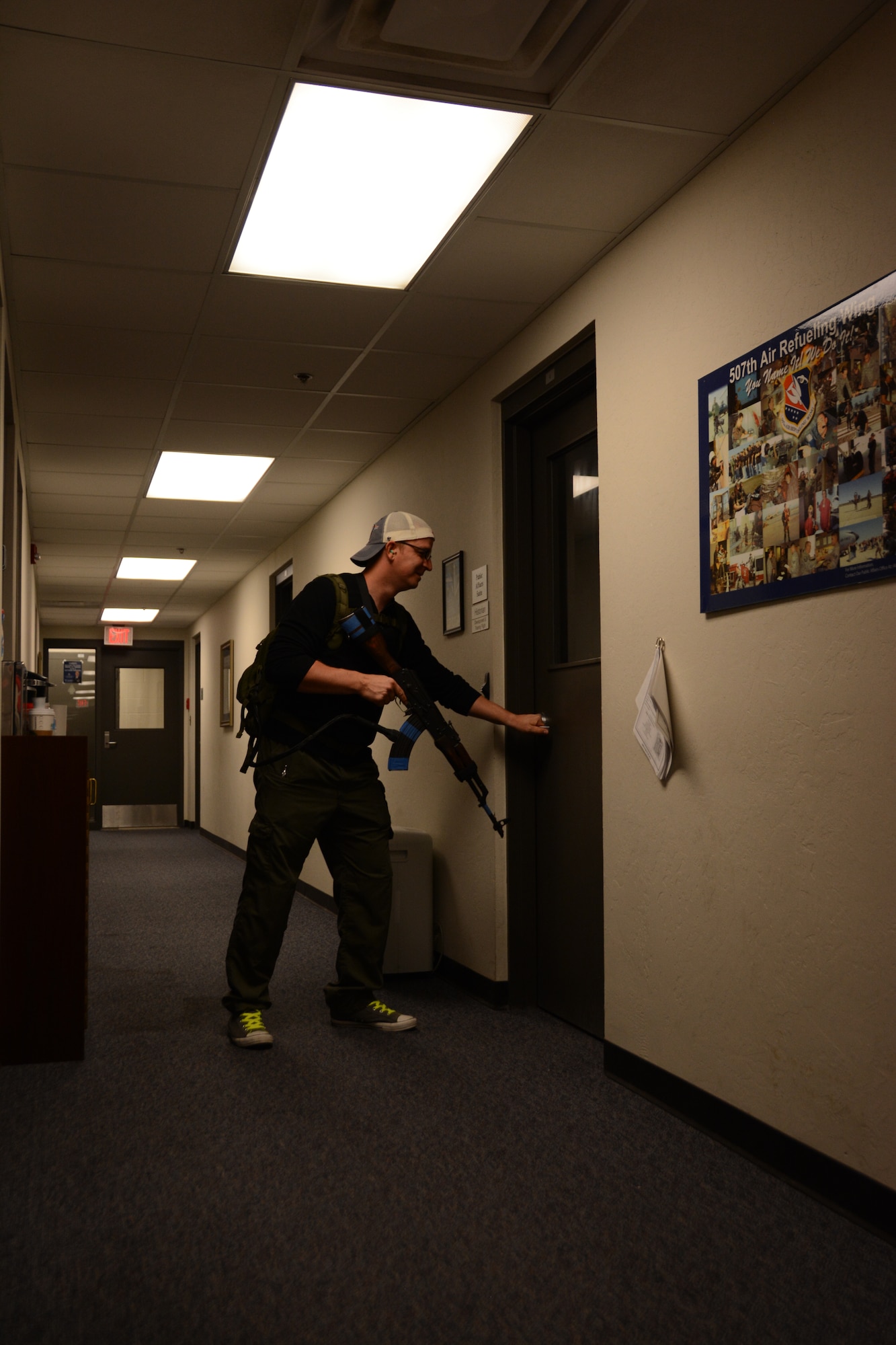 Tech. Sgt. Darryl Lindgens, mock active shooter, attempts to gain entry to an office at the 507th Air Refueling Wing headquarters building during an active shooter exercise Aug. 11, 2015, at Tinker Air Force Base, Okla. This is the third active shooter exercise at the base this year. (U.S. Air Force photo by Tech. Sgt. Lauren Gleason)