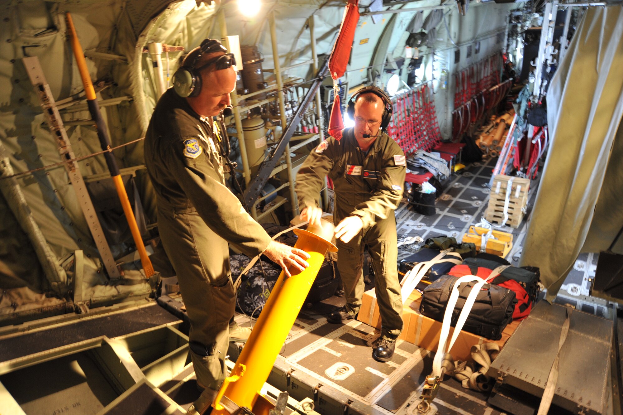 U.S. Coast Guard 1st Class Petty Officer Steve Jayne, a reservist who works
as a senior scientist with Woods Hole Oceanographic Institution, deploys a
several Air-Launched Autonomous Micro-Observer profiling floats, commonly
referred to as ALAMO, during Tropical Storm Erika over the Gulf of Mexico,
Aug. 28,2015 . The ALAMO is an upgrade from the Airborne eXpendable
BathyThermographs, or AXBTs. The ALAMO provides more temperature profiles
than the AXBT, but both send data by a radio signal from the ocean surface
while diving down 800 meters into the water. This summer Jayne worked with
the Naval Academy's Training and Research in Oceanic and Atmospheric
Processes in Tropical Cyclones, or TROPIC, program, which is doing research
to determine how the relationship between the ocean and a hurricane can
improve forecasts of storm track and intensity.  (U.S. Air Force photo/Maj.
Marnee A.C. Losurdo)
