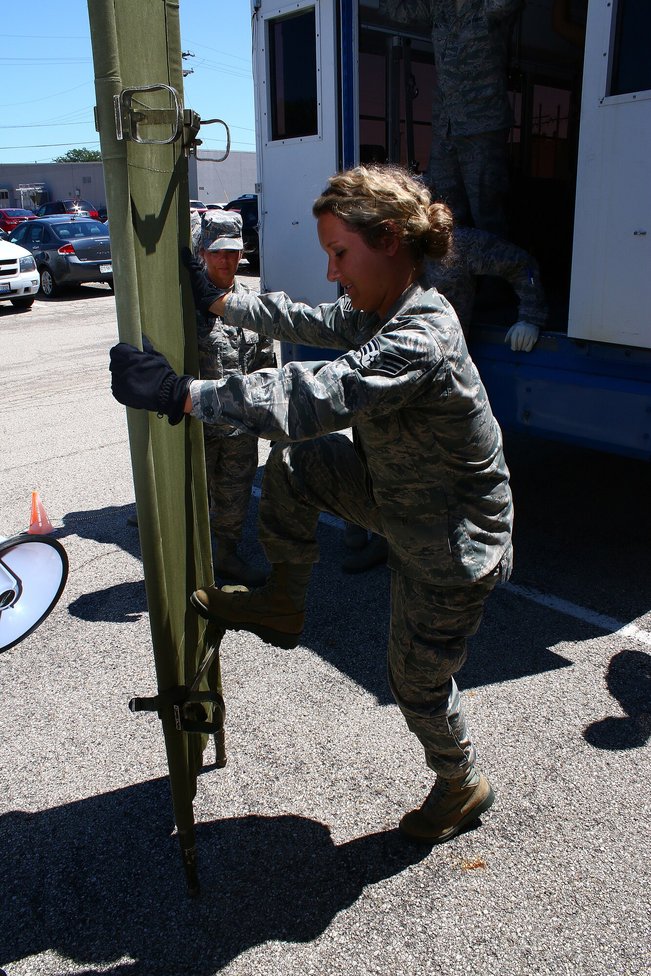 WRIGHT-PATTERSON AIR FORCE BASE, Ohio – Senior Airman Courtney Kalb, 445th Aeromedical Staging Squadron, demonstrates how to break down a litter during a training exercise outside the ASTS facility Aug. 2, 2015. This was among many of the exercises practiced over the August unit training assembly. (U.S. Air Force photo /Tech. Sgt. Patrick O’Reilly)