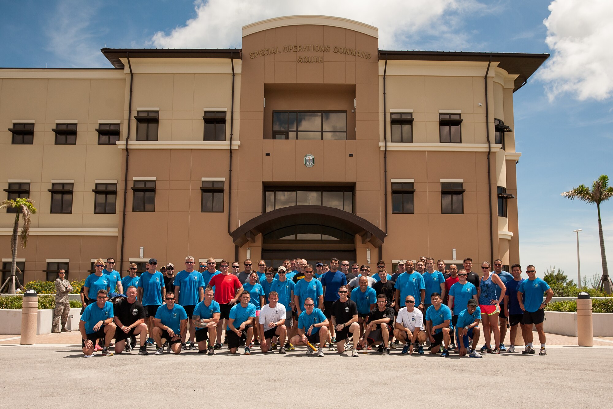 Service and family members of Special Operations Command South pose for a photo Sept. 11, 2015, at the unit's headquarters at Homestead Air Reserve Base, Fla., after completing a 140-mile relay run to commemorate the fourteenth anniversary of the tragic events of 9/11. A small tribute followed the race in which the fallen were recognized by Homestead, Fla., Mayor Jeff Porter and SOCSOUTH leadership. (U.S. Army photo by Staff Sgt. Osvaldo Equite/Released)
