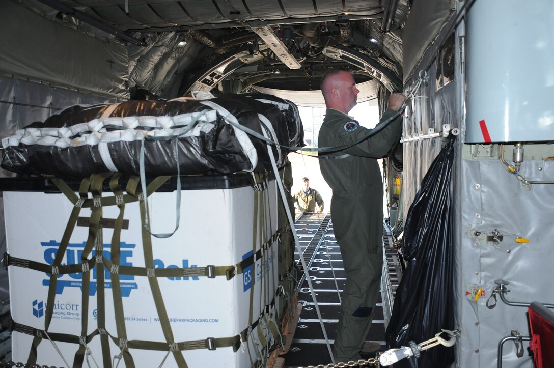 Staff Sgt. Pat Englishby (front), loadmaster, 328th Airlift Squadron, secures an palette inside a C-130 Hercules aircraft while Senior Airman Ken Zidell, loadmaster, 328 AS assists, at Ramstein Air Base, Germany, on Aug. 21, 2015. Englishby and Zidell were participating in Exercise Swift Response, a multinational training exercise. (U.S. Air Force photo by Staff Sgt. Matthew Burke/released)