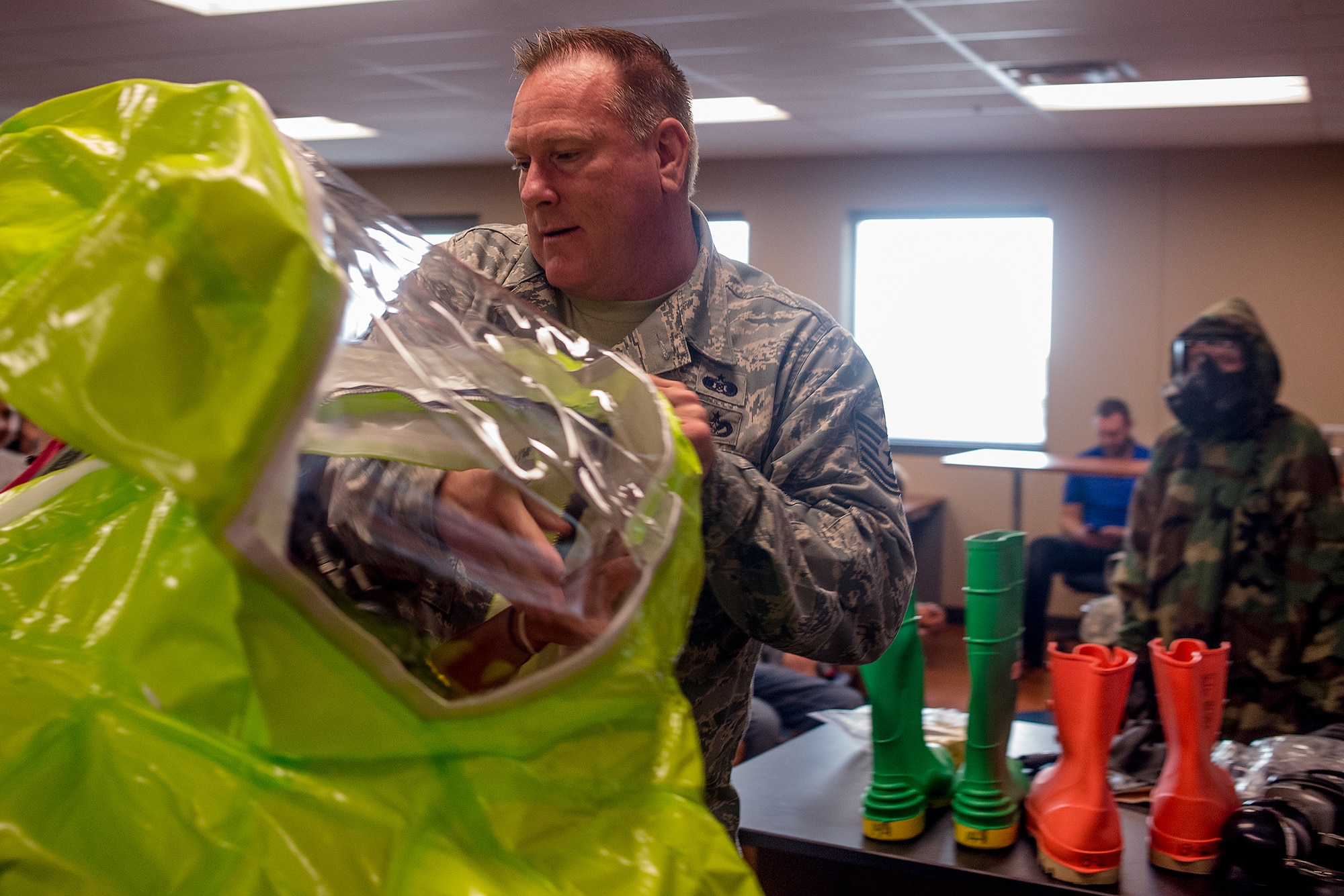 Tech Sgt. Tim Cotterall, 137th Civil Engineering Squadron emergency management specialist demonstrates hazardous materials safety equipment at Deer Creek Middle School, Edmond, Okla. on September 8, 2015. Tech Sgt. Cotterall spends time every September educating the students on the  hazardous materials in the home that can cause serious injury. (U.S. Air National Guard photo by Master Sgt. Andrew LaMoreaux/Released)