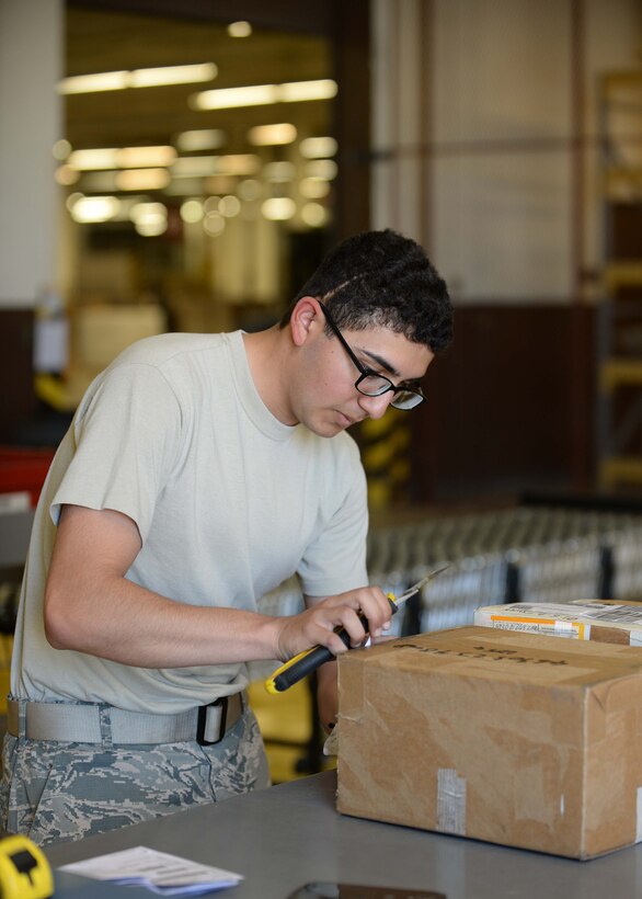 Airman 1st Class Barney Lopez, 28th Logistics Readiness Squadron receiving technician, verifies a package at Ellsworth Air Force Base, S.D., Sept. 1, 2015. Receiving technicians must validate and authenticate each package in order to ensure facilities on base receive the appropriate parts they need to meet mission requirements. (U.S. Air Force photo by Senior Airman Rebecca Imwalle/Released)