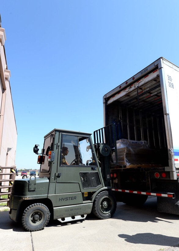 Airman 1st Class Barney Lopez, 28th Logistics Readiness Squadron receiving technician, unloads deliveries at Ellsworth Air Force Base, S.D., Sept. 1, 2015. Shipments of mission critical parts must be processed and delivered to the appropriate maintenance shop within a strict time frame to ensure that maintenance Airmen have what they need to sustain mission readiness at all times. (U.S. Air Force photo by Senior Airman Rebecca Imwalle/Released)