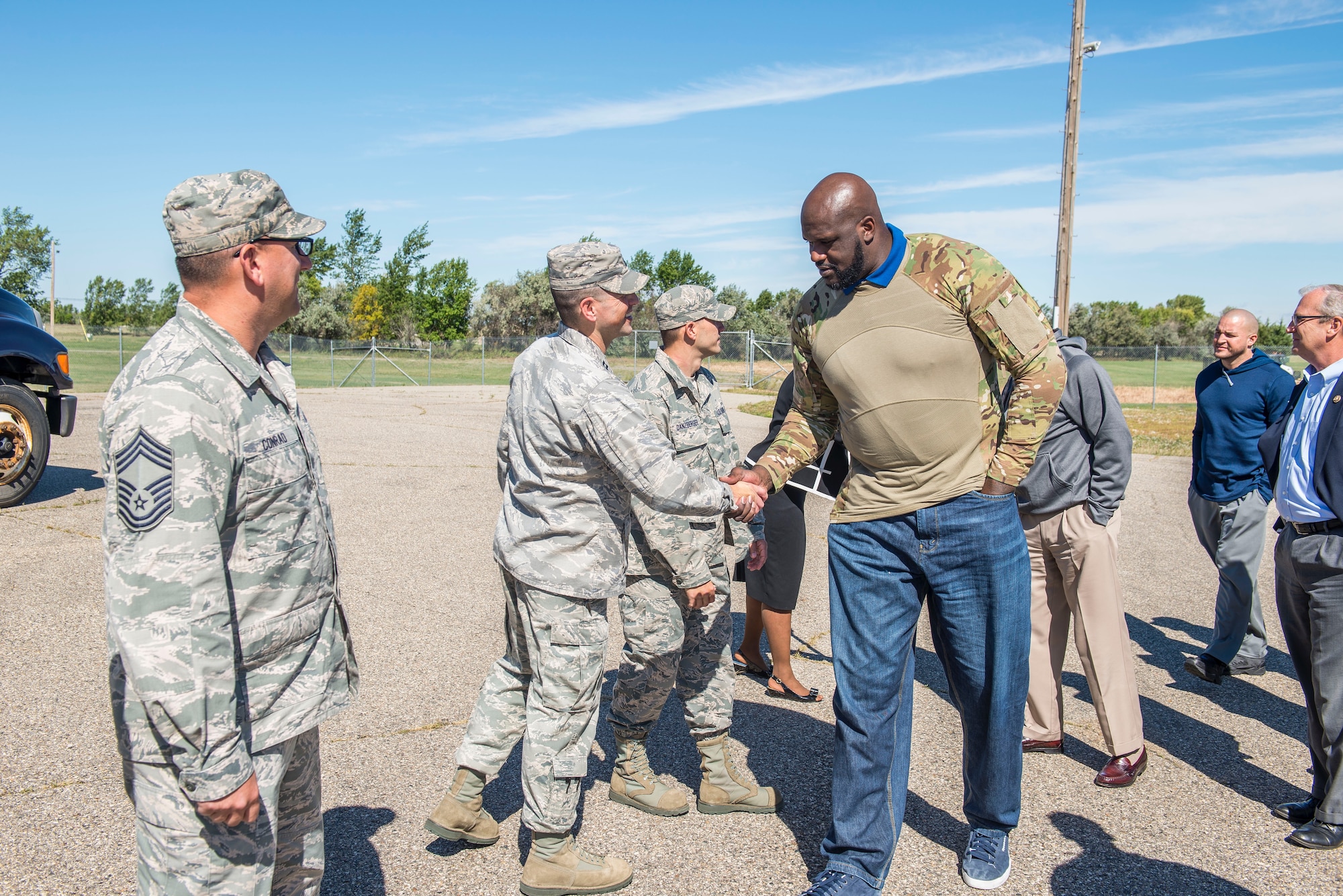 Shaquille O’Neil, former professional basketball player, is greeted by Airmen from the 91st Missile Wing at Minot Air Force Base, N.D., September 8, 2015. As a part of their base visit, O’Neil, Dale Brown, former college basketball coach, and Kevin Cramer, congressman, toured a B-52H Stratofortress, the Uniform 1 missile training facility, McAdoo Fitness Center, the base theater and Rockers Bar and Grill to meet with and speak to Minot personnel and families. (U.S. Air Force photo/ Airman 1st Class Justin T. Armstrong)
