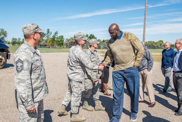 Shaquille O’Neal, former professional basketball player, is greeted by Airmen from the 91st Missile Wing at Minot Air Force Base, N.D., September 8, 2015. As a part of their base visit, O’Neal, Dale Brown, former college basketball coach, and Kevin Cramer, congressman, toured a B-52H Stratofortress, the Uniform 1 missile training facility, McAdoo Fitness Center, the base theater and Rockers Bar and Grill to meet with and speak to Minot personnel and families. (U.S. Air Force photo/ Airman 1st Class Justin T. Armstrong) 
