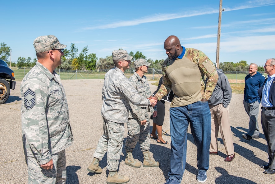 Shaquille O’Neil, former professional basketball player, is greeted by Airmen from the 91st Missile Wing at Minot Air Force Base, N.D., September 8, 2015. As a part of their base visit, O’Neil, Dale Brown, former college basketball coach, and Kevin Cramer, congressman, toured a B-52H Stratofortress, the Uniform 1 missile training facility, McAdoo Fitness Center, the base theater and Rockers Bar and Grill to meet with and speak to Minot personnel and families. (U.S. Air Force photo/ Airman 1st Class Justin T. Armstrong)
