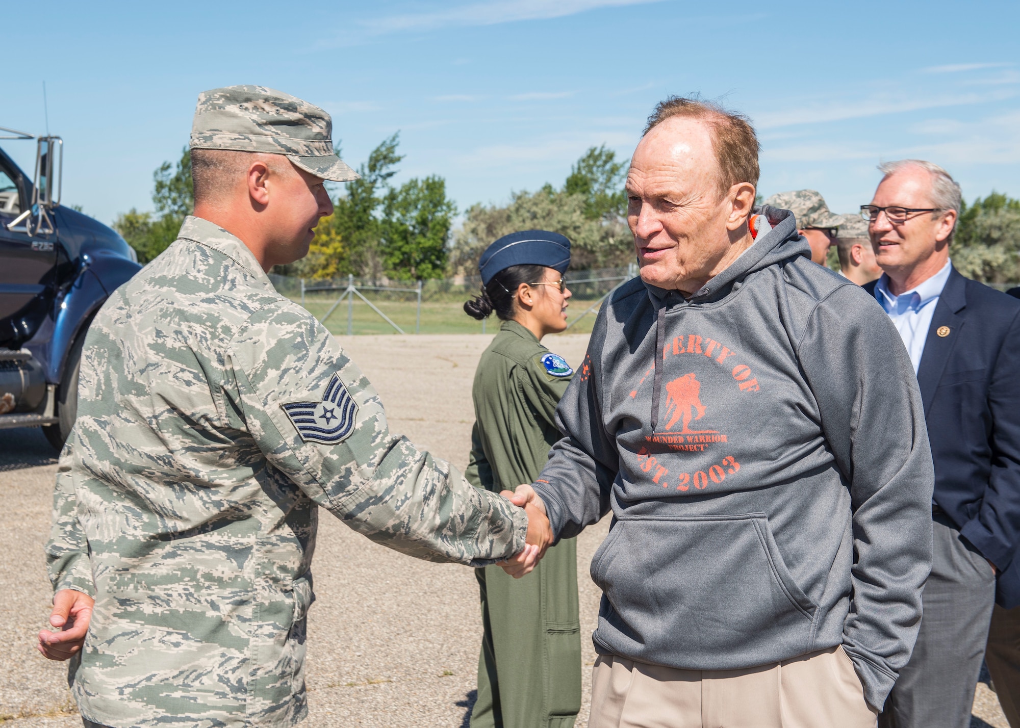 Dale Brown, former college basketball coach, is greeted by Airmen from the 91st Missile Wing at Minot Air Force Base, N.D., September 8, 2015. As a part of their base visit, Brown, Shaquille O’Neil, former professional basketball player, and Kevin Cramer, congressman, toured a B-52H Stratofortress, the Uniform 1 missile training facility, McAdoo Fitness Center, the base theater and Rockers Bar and Grill to meet with and speak to Minot personnel and families. (U.S. Air Force photo/ Airman 1st Class Justin T. Armstrong)