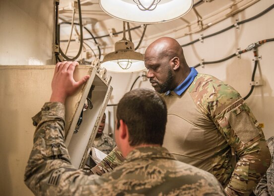 Shaquille O’Neal, former professional basketball player, looks through a book of procedures in the underground portion of the Uniform 1 missile training facility at Minot Air Force Base, N.D., September 8, 2015. O’Neal visited the Uniform 1 missile training facility and toured above and below-ground portions of the facility to watch Airmen train. (U.S. Air Force photo/ Airman 1st Class Justin T. Armstrong) 
