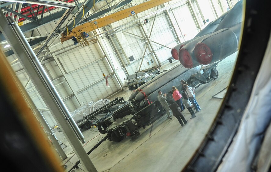 Tech. Sgt. Phillip Plinski, 5th Maintenance Group load standardization crew team chief, explains weapons carried by the B-52H Stratofortress to Team Minot spouses at Minot Air Force Base, N.D., Sept. 9, 2015. The group was given tours of various base facilities such as the weapons system trainer and dock 7. (U.S. Air Force photo/Senior Airman Stephanie Morris)