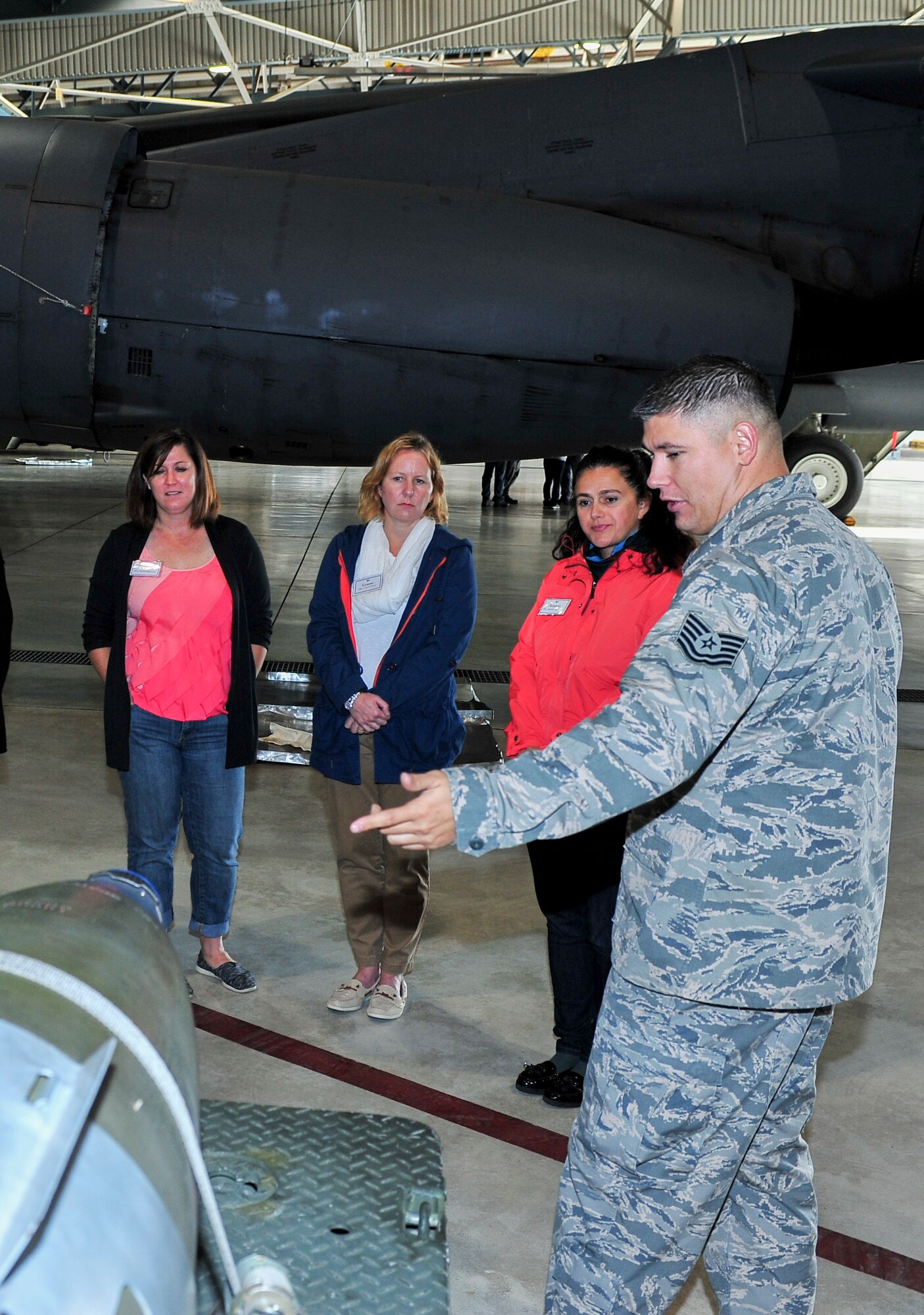 Tech. Sgt. Phillip Plinski, 5th Maintenance Group load standardization crew team chief, explains weapons carried by the B-52H Stratofortress to Team Minot spouses at Minot Air Force Base, N.D., Sept. 9, 2015. The group was given tours of various base facilities such as the weapons system trainer and dock 7. (U.S. Air Force photo/Senior Airman Stephanie Morris)