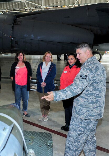 Tech. Sgt. Phillip Plinski, 5th Maintenance Group load standardization crew team chief, explains weapons carried by the B-52H Stratofortress to Team Minot spouses at Minot Air Force Base, N.D., Sept. 9, 2015. The group was given tours of various base facilities such as the weapons system trainer and dock 7. (U.S. Air Force photo/Senior Airman Stephanie Morris)
