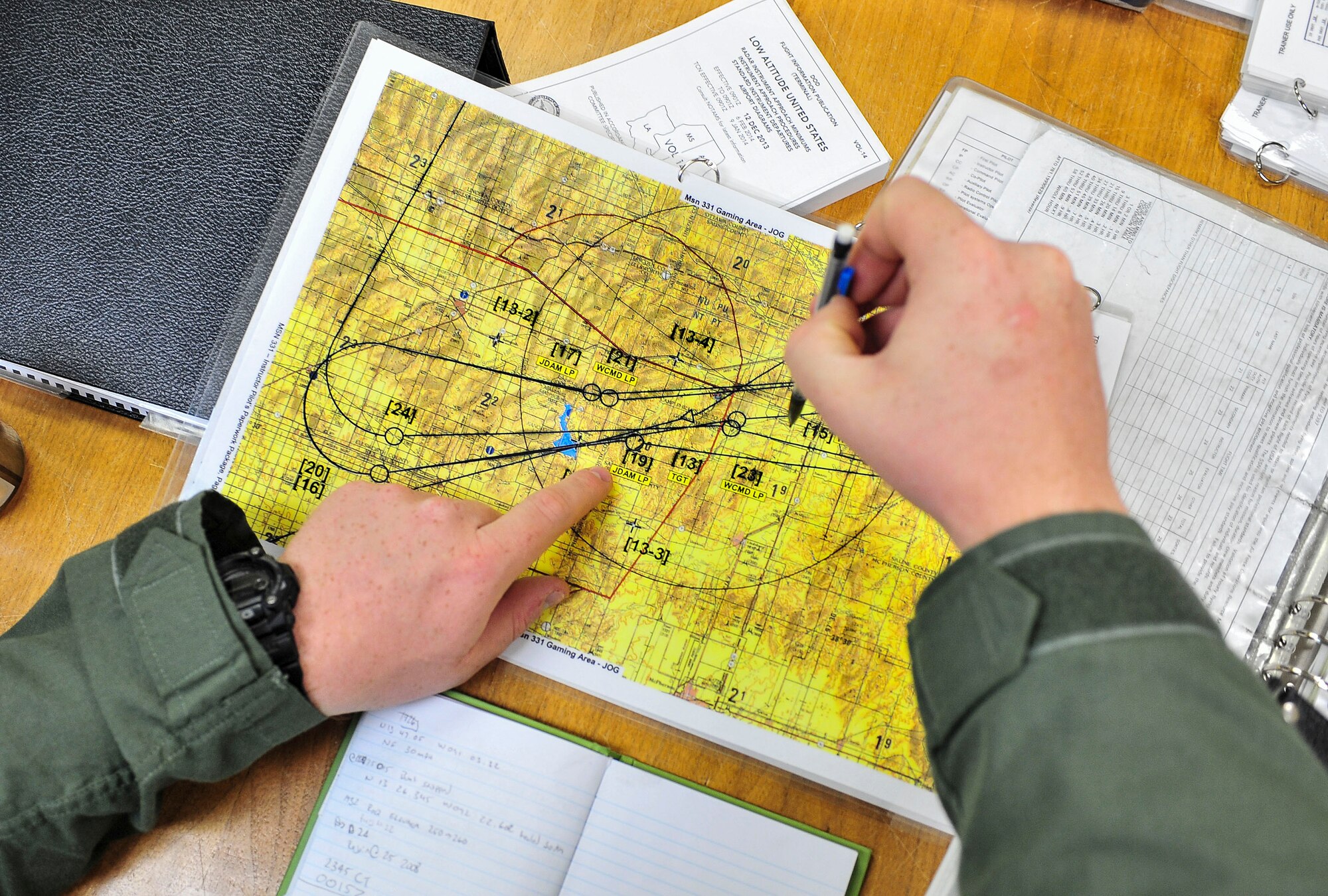 A member of the 69th Bomb Squadron reviews simulated flight plans at Minot Air Force Base, N.D., Sept. 8, 2015. The 69th BS is preparing to participate in Air Force Global Strike Command’s Global Strike Challenge, the world's premier bomber, intercontinental ballistic missile, helicopter and security forces competition. (U.S. Air Force photo/Senior Airman Stephanie Morris)