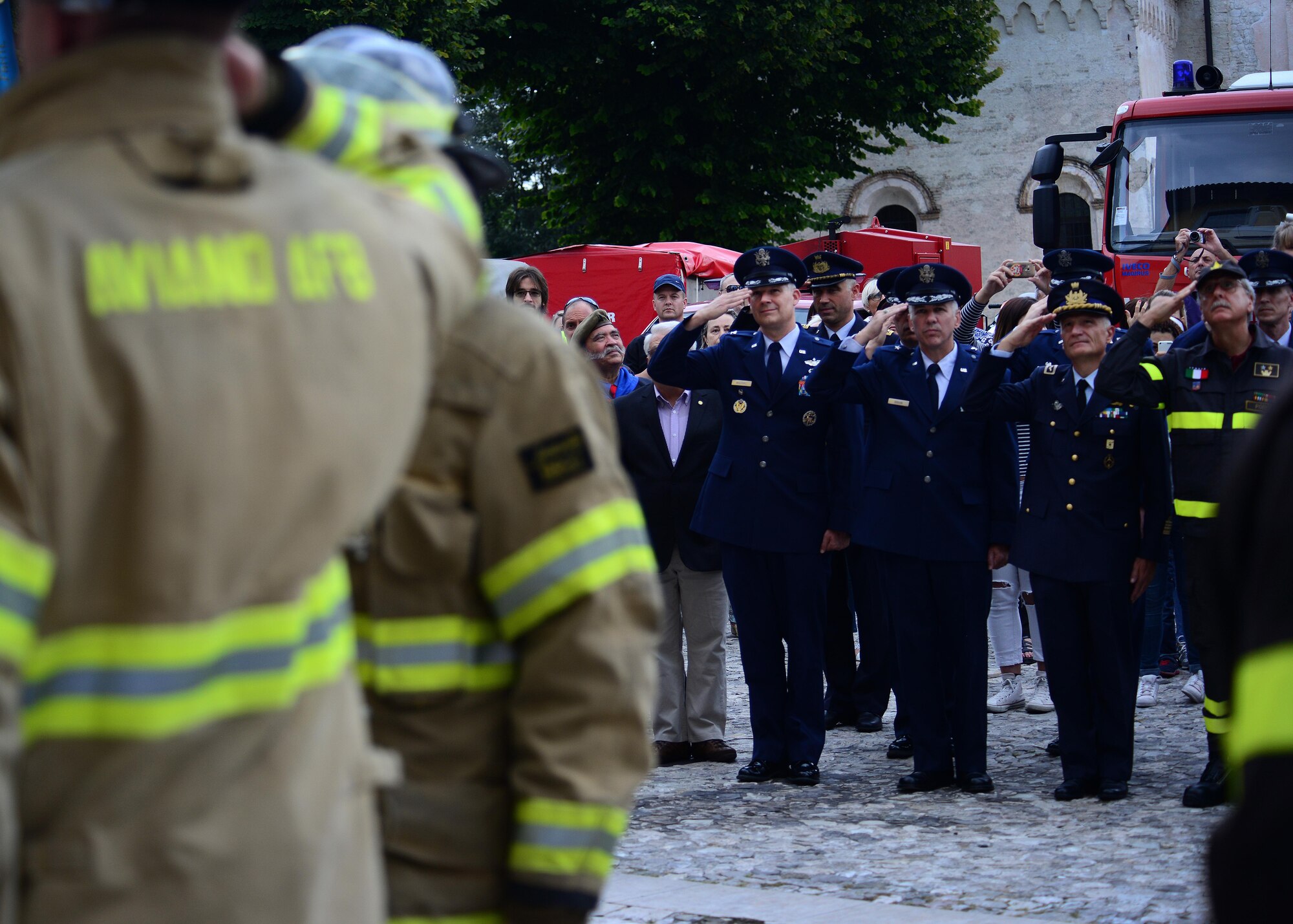 Aviano Air Base and Italian community leaders salute the U.S. flag during a ceremony at the 14th Annual Italian-American Friendship Festival, on Sept. 12, 2015 in Spilimbergo, Italy. The festival allowed Team Aviano an opportunity to strengthen bonds with their host nation community. The event also included several demonstrations, food, sports tournaments, music and a ceremony. (U.S. Air Force photo by  Staff Sgt. Evelyn Chavez/Released)