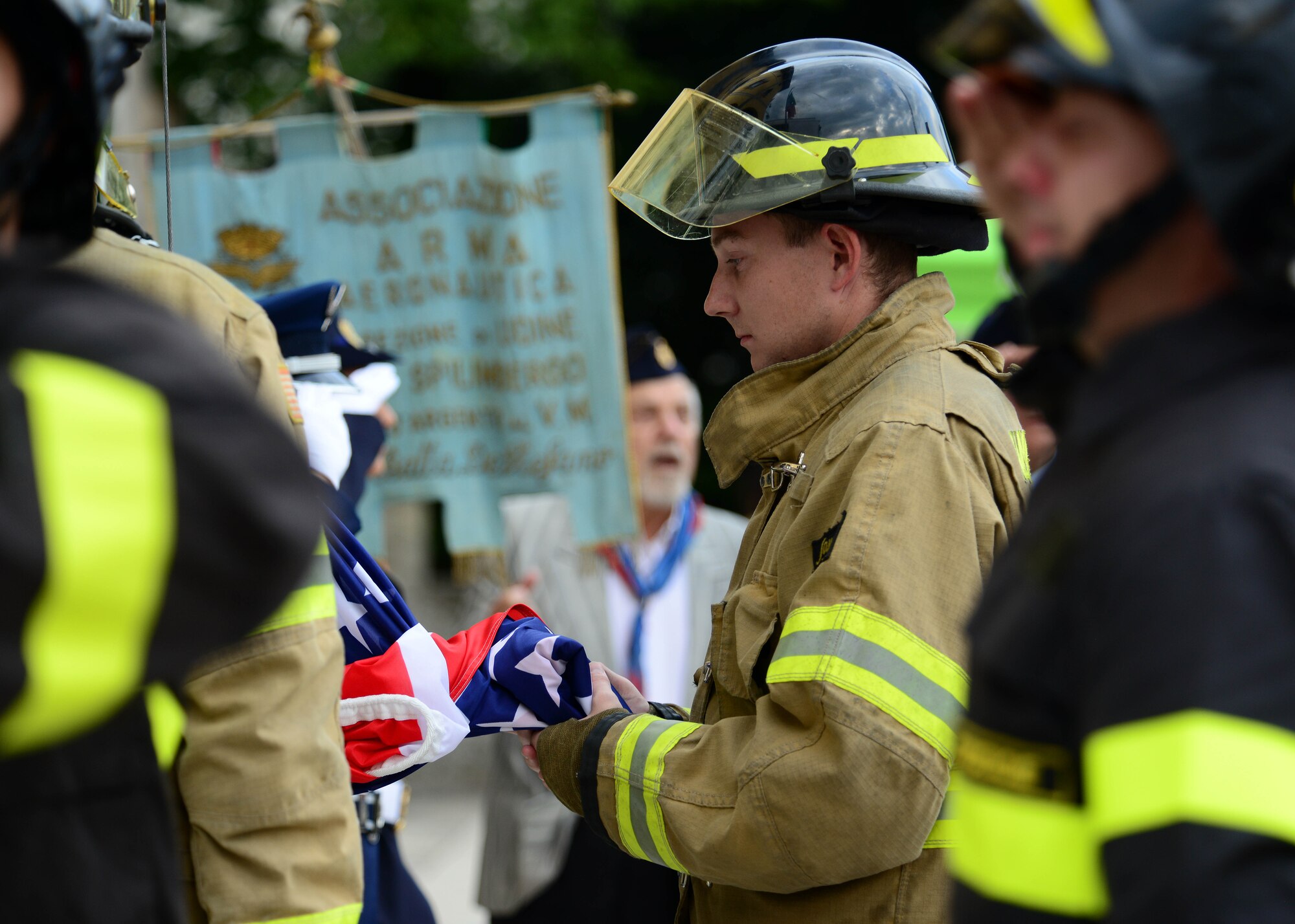 A U.S. Air Force Airman with the 31st Civil Engineer Squadron  Italian holds the U.S. flag during a ceremony at the 14th Annual Italian-American Friendship Festival, on Sept. 12, 2015, in Spilimbergo, Italy. The festival allowed Team Aviano an opportunity to strengthen bonds with their host nation community. The event also included several demonstrations, food, sports tournaments, music and a ceremony. (U.S. Air Force photo by  Staff Sgt. Evelyn Chavez/Released)